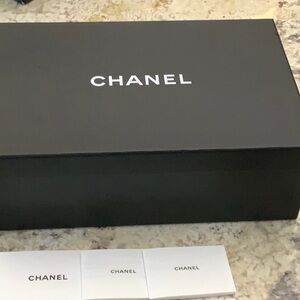 Chanel empty box with 3 papers with Chanel on them
